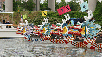 The PKSCA's early Traditional-Style Dragon Boats lined up at the start line for a race.