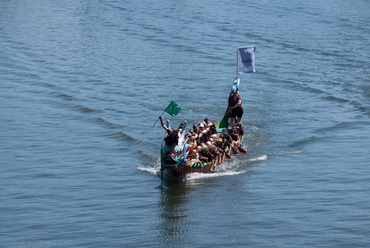 Full Dragon Boat at End of Race with Flag Captured.