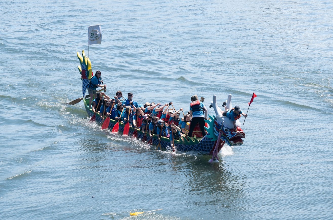 Full Dragon Boat at End of Race with Flag Captured.