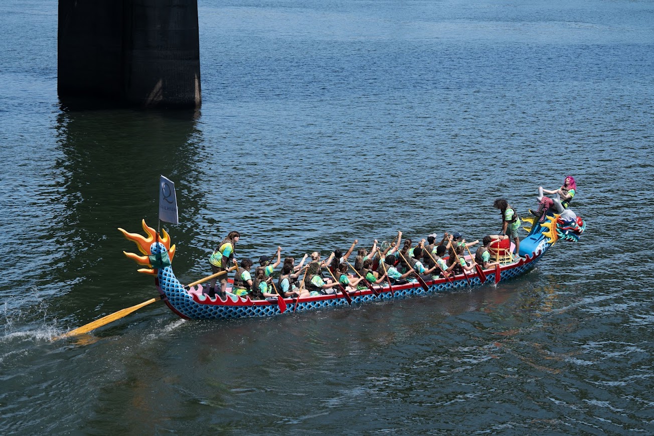 Side view of Traditional-Style Dragon Boat returning after race.
